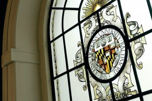 Johns Hopkins University seal in a stained glass window