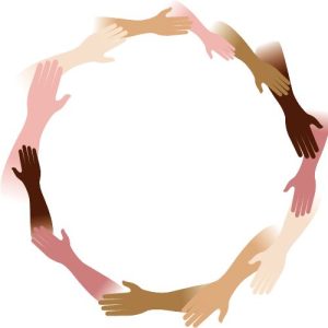 Multi-colored hands laying over each other.
